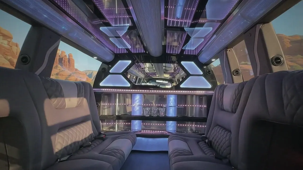 Inside the Cadillac Escalade limo in Greenwood Village: LED light-show ceiling, leather lounge seating and lit bar